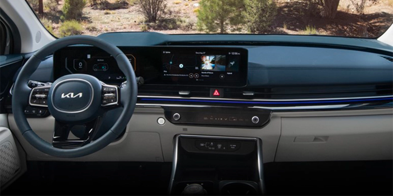 Interior dashboard and steering wheel of Kia Carnival.