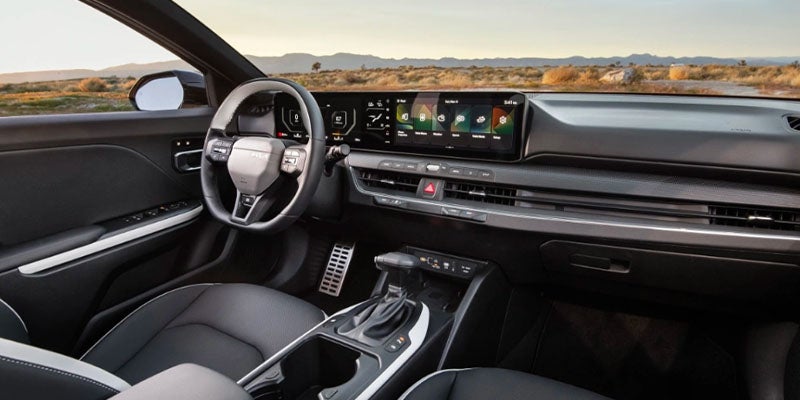 Interior view of the Kia K4 showcasing the digital dashboard, steering wheel, and advanced safety technology