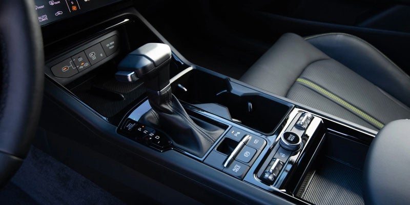 Close-up of the Kia K5 center console with gear shifter and storage space