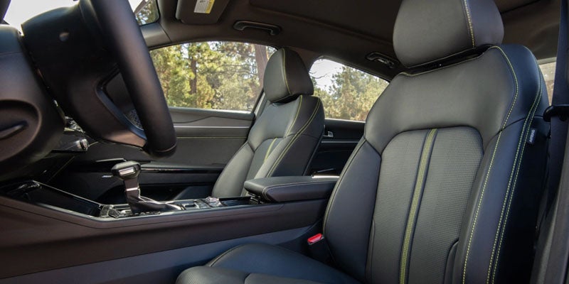Front seats of the Kia K5 featuring premium stitching and modern interior design.