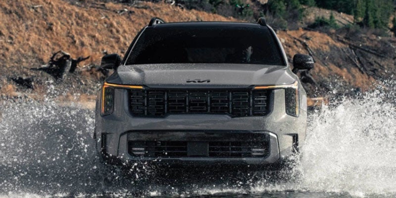 A gray SUV with its drives in water