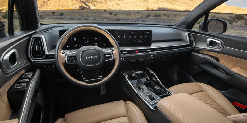 The interior dashboard of an SUV with a large curved screen