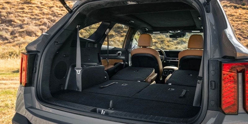 The open trunk of a gray SUV, with the seats folded down