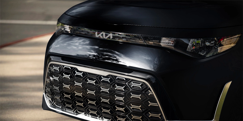 The grille and headlight of a black Kia Soul